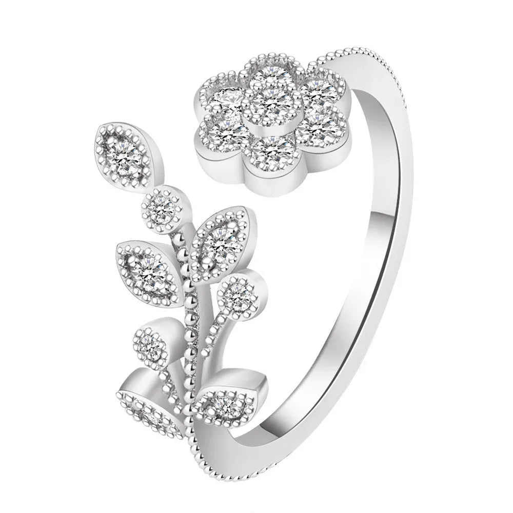 Women's open ring with diamond flower and leaf pattern in copper, shown in gold and white colour options.