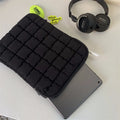 Black and white nylon laptop bag for 11-inch to 15.6-inch devices with large storage capacity.