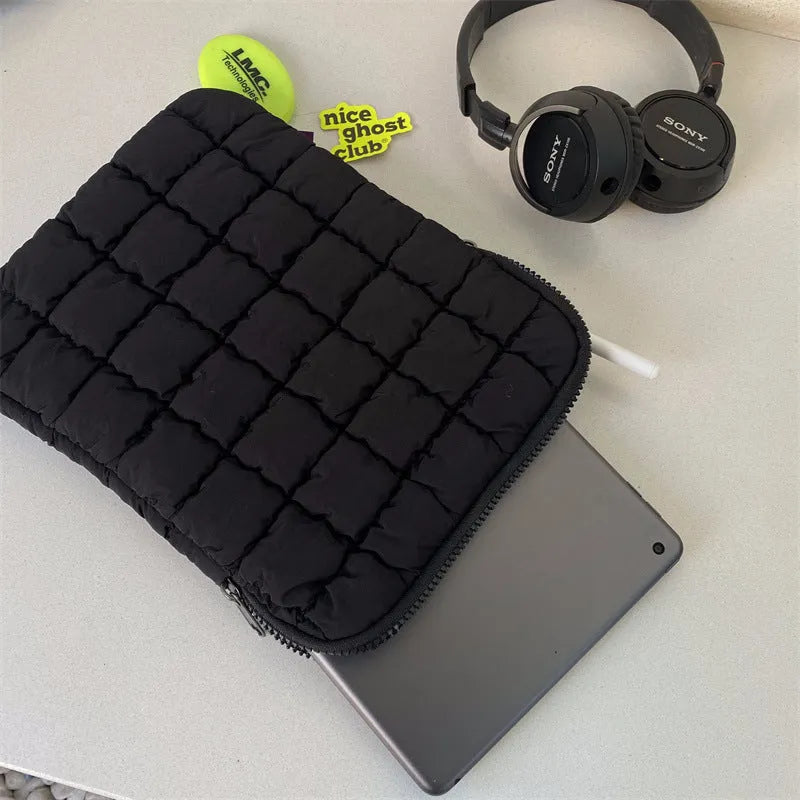 Black and white nylon laptop bag for 11-inch to 15.6-inch devices with large storage capacity.