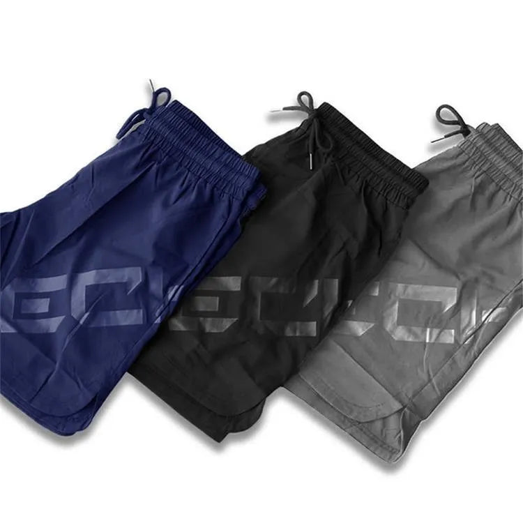 Men's black elastic waist knee-length quick-dry training shorts on a white background.