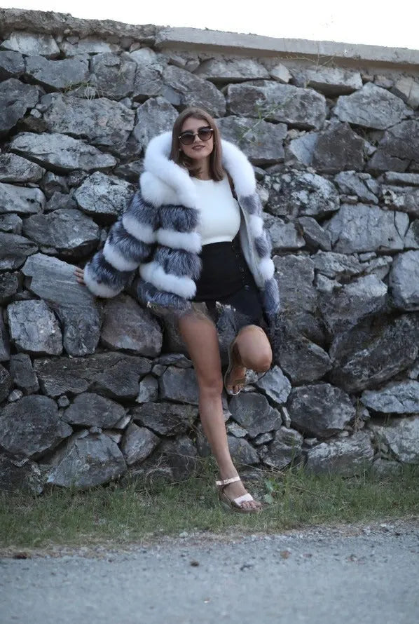 Women's loose artificial fur coat with hood in brown colour on mannequin