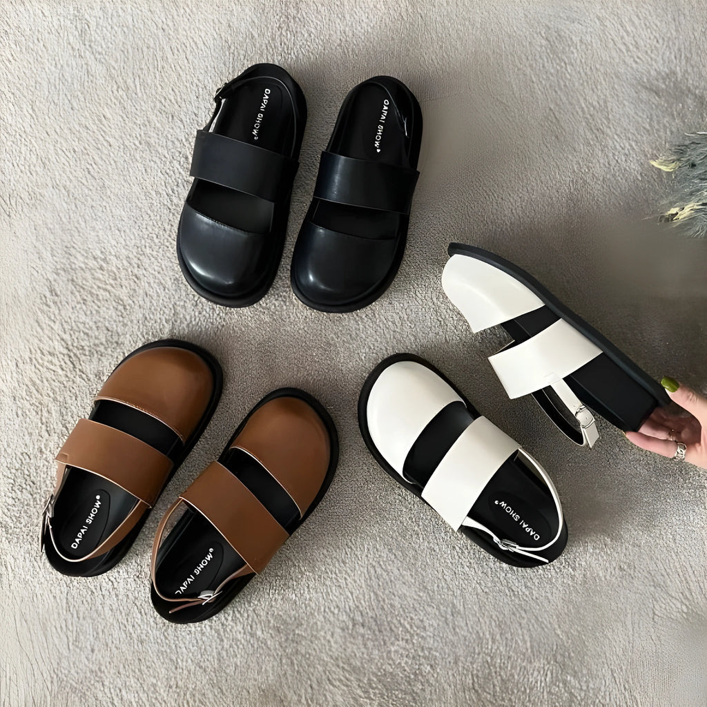 Retro style closed toe sandals with a single ankle buckle strap in apricot colour.