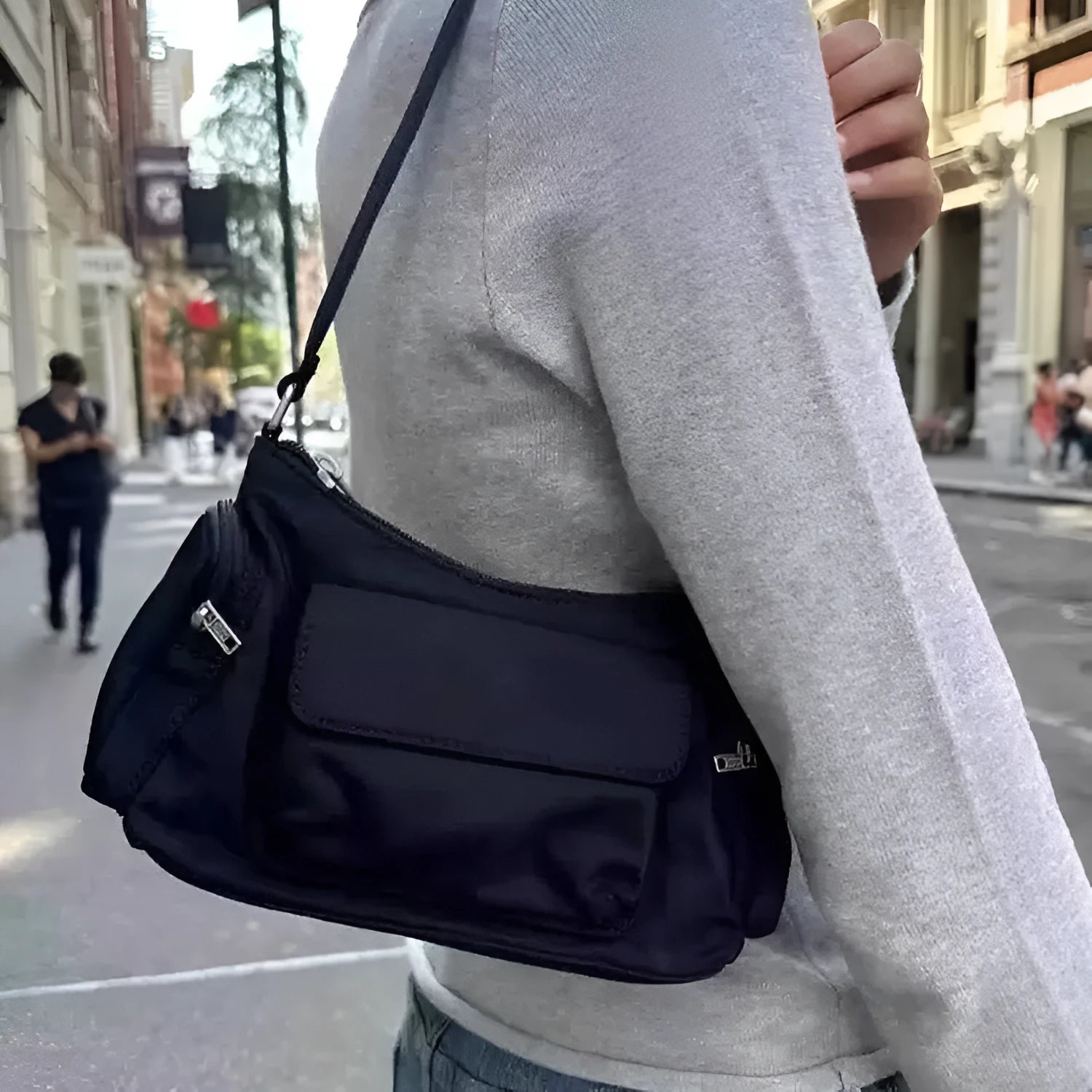 Black lightweight women's shoulder bag with double pockets and a side line design.