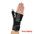 Black carbon fibre pattern wrist guard with grey edging and a thumb strap.