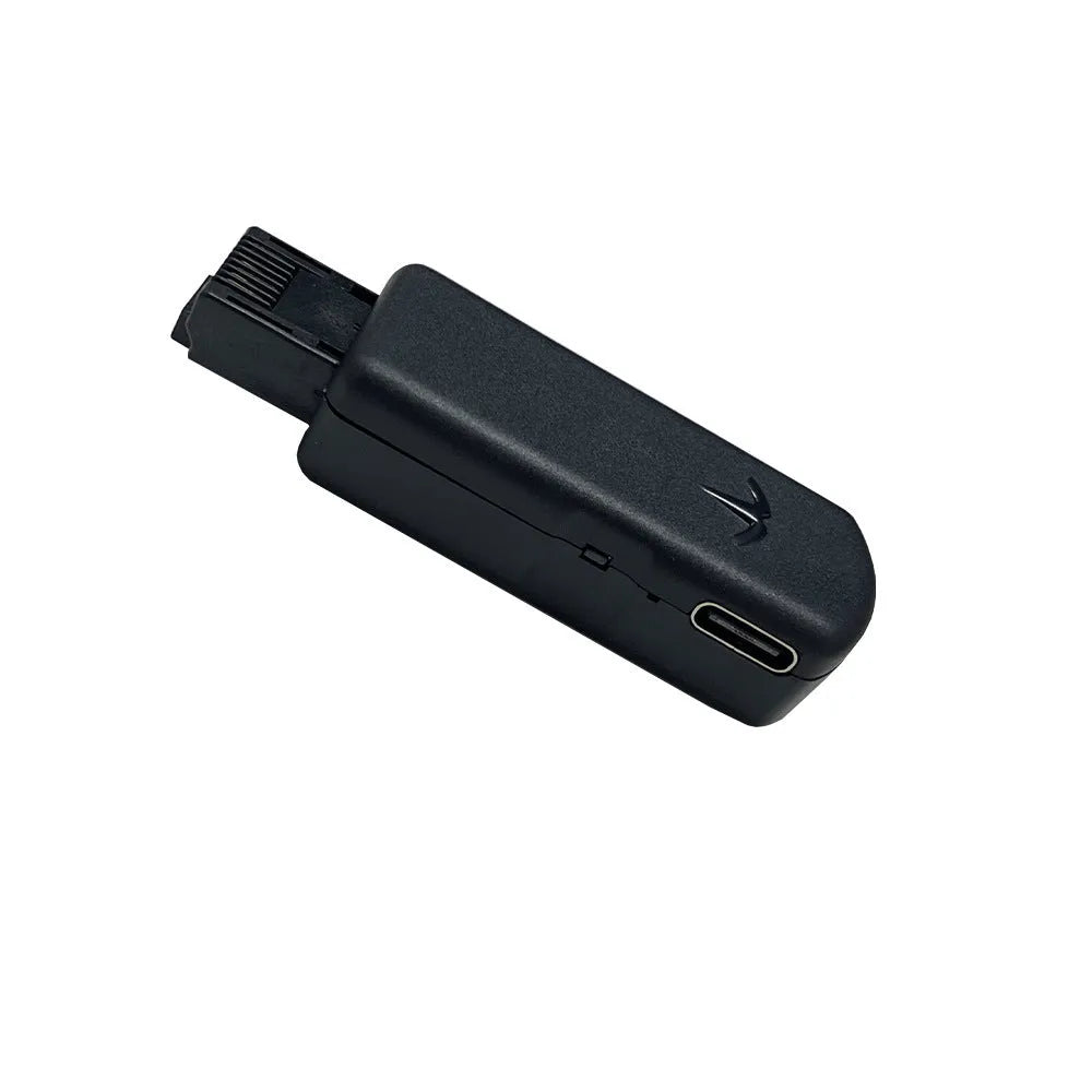 Black aluminium alloy PS4 USB firmware tool with data cable on a dark surface.