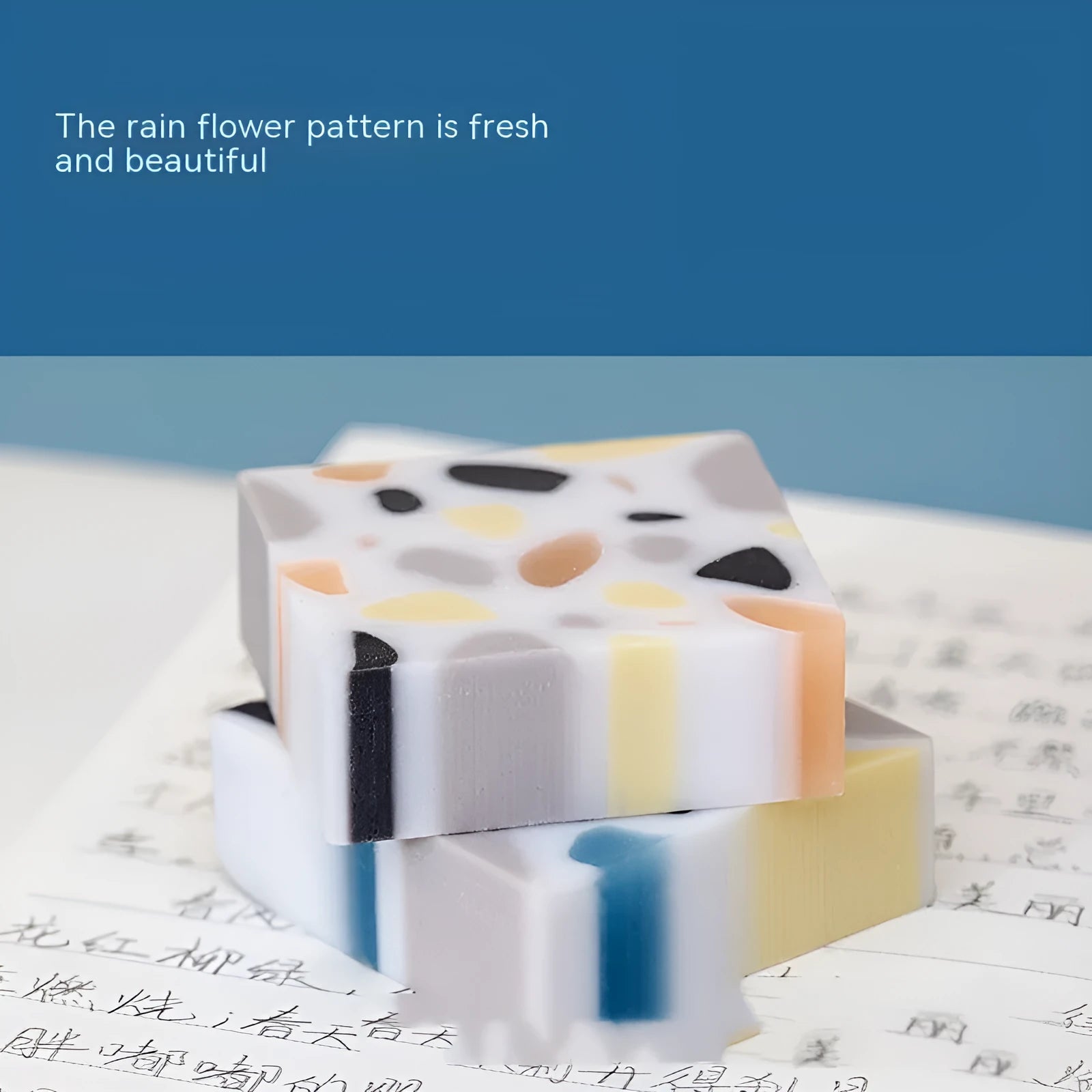 White brick-shaped rubber eraser on a flat surface.