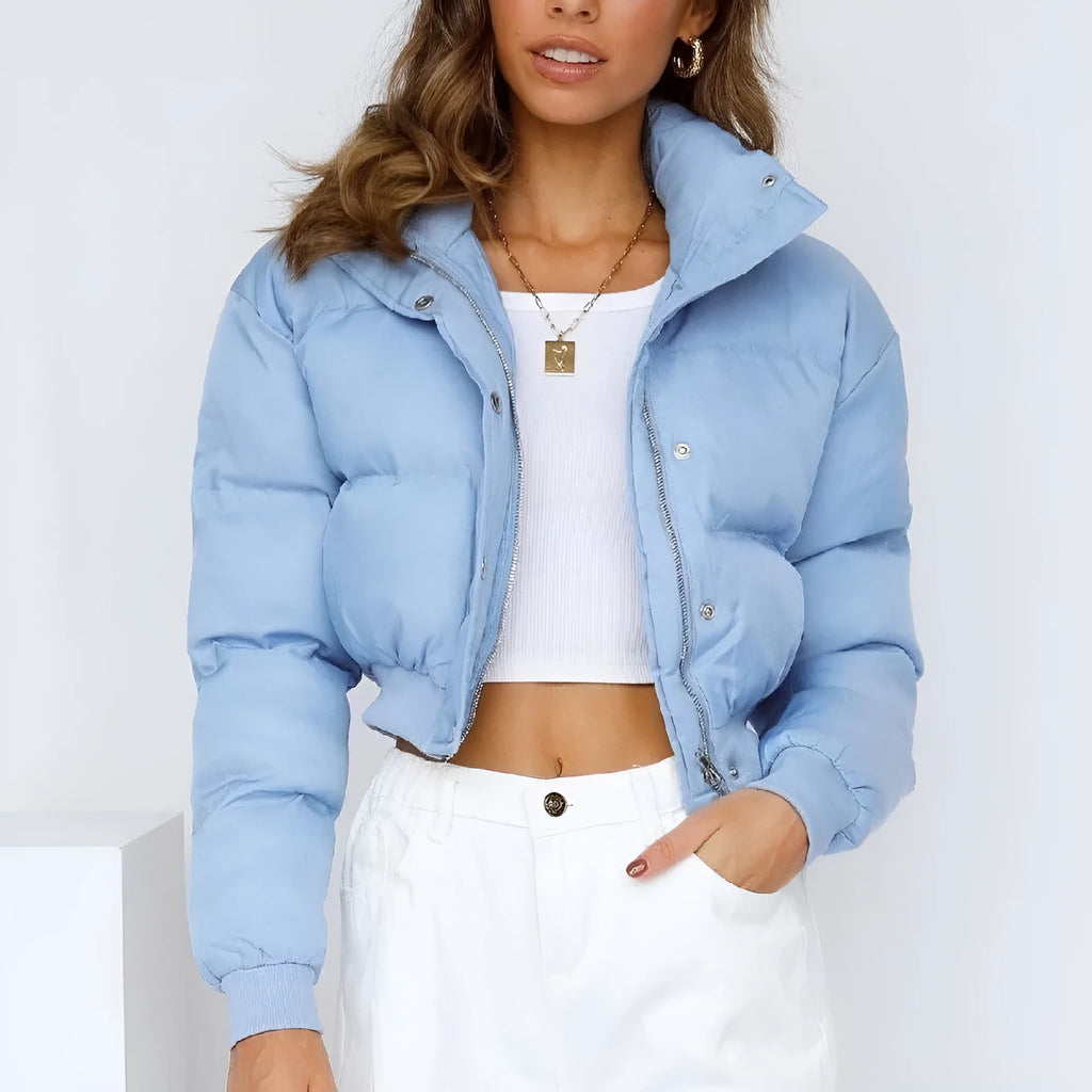 Blue loose fit polyester jacket for women with long sleeves on a hanger.