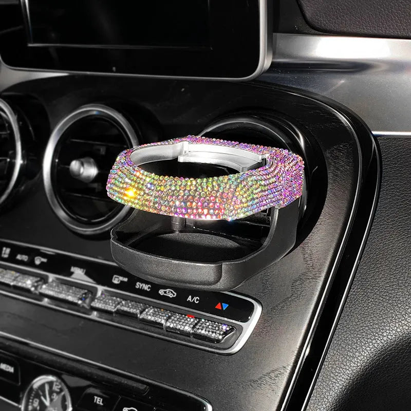 White diamond-encrusted ABS plastic car cup holder bracket mounted on a car air vent.