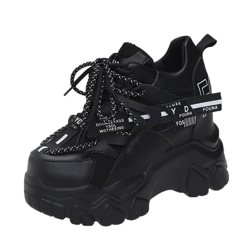 Women's white and black mesh platform tennis shoes with cross strap and thick rubber sole.