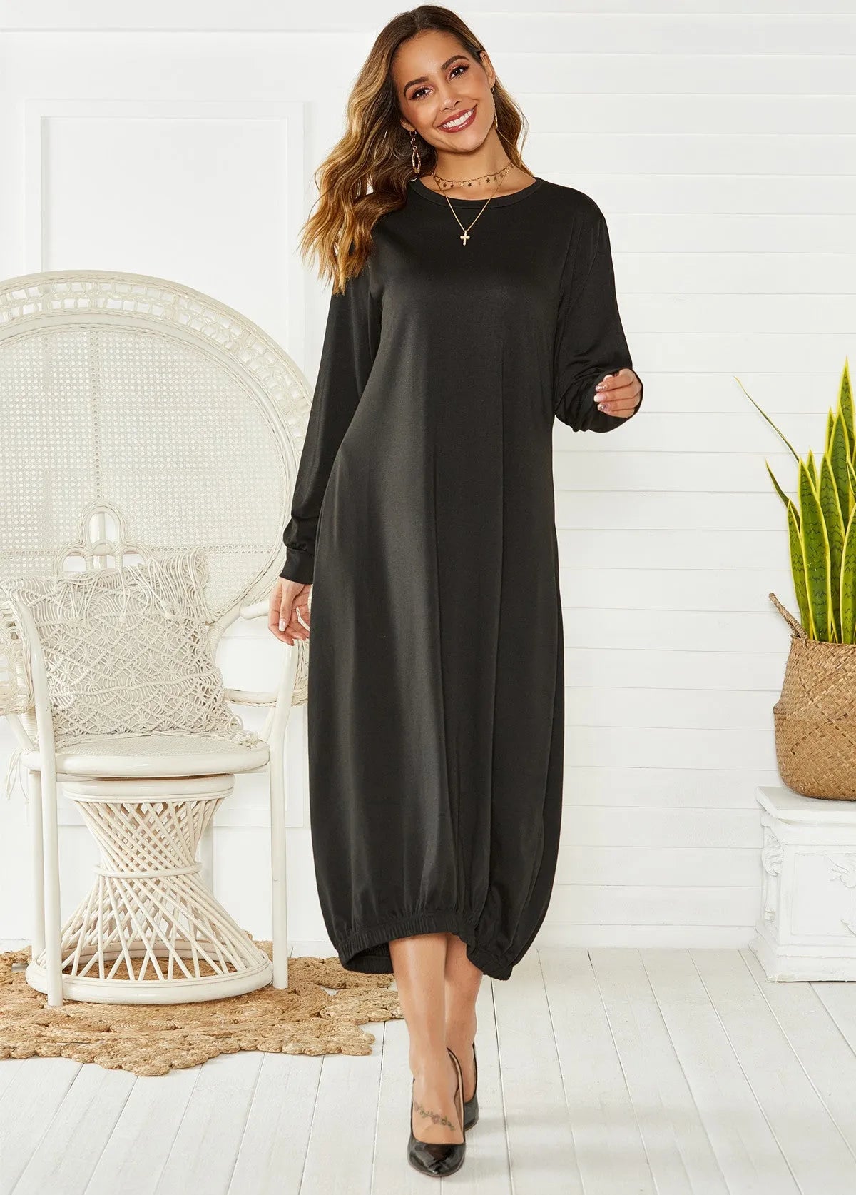 A grey loose-fitting long lantern dress with long sleeves and a crew neckline, laid flat.