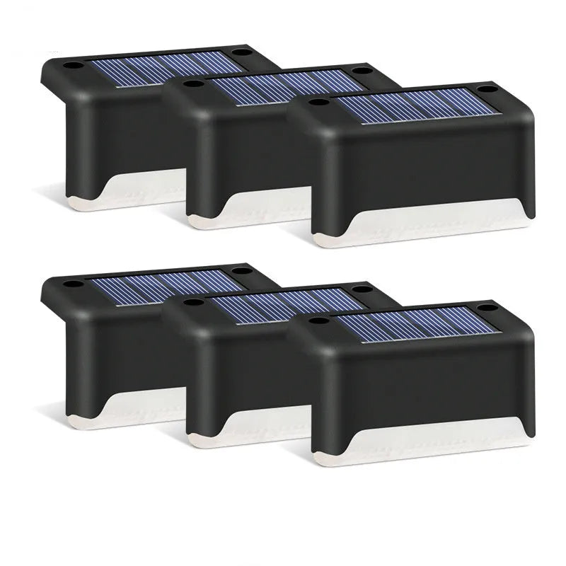black solar courtyard stair light with ABS body on a garden step