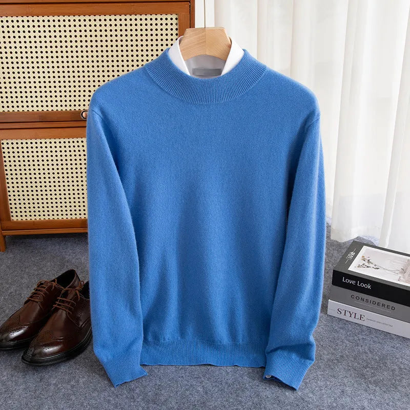 Man wearing a loose-fit, chunky knit wool sweater with a half-turtleneck collar in a neutral colour.