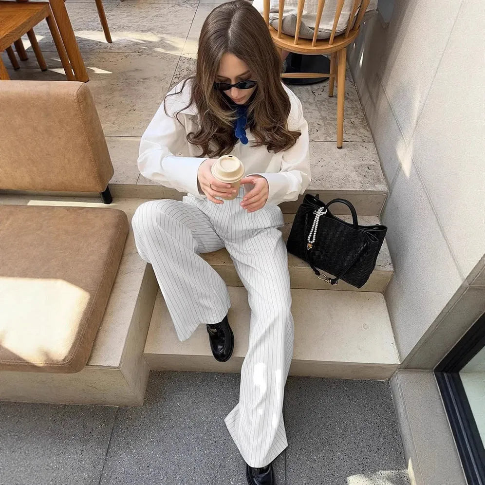 White striped wide-leg women's trousers with zipper, loose fit for commuting.