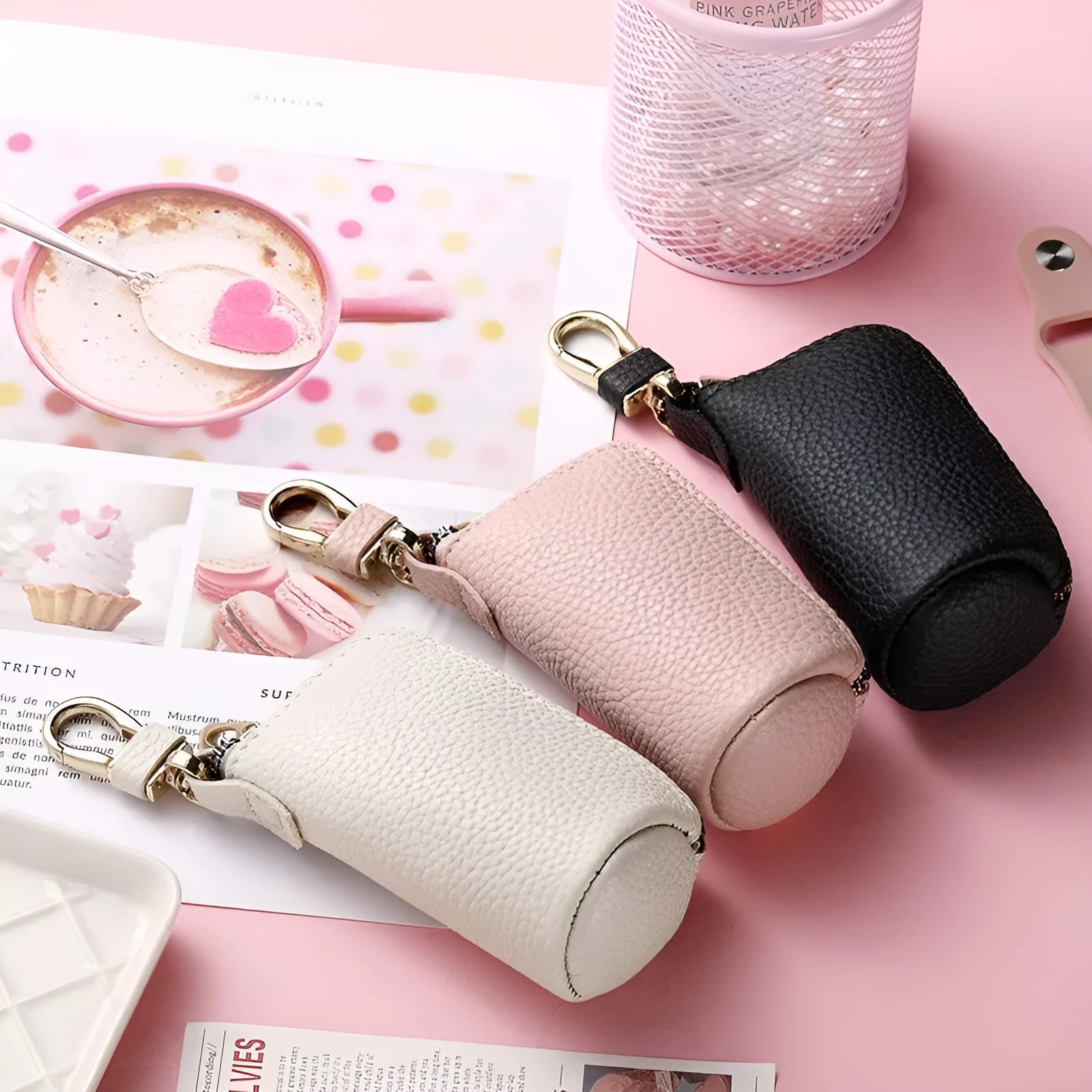 Simple black PU leather zipper key ring case on a grey background.