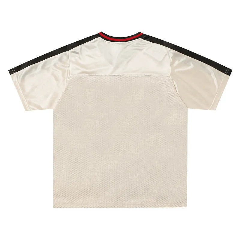 Apricot coloured loose-fit V-neck sports jersey top with short sleeves and a letters pattern.