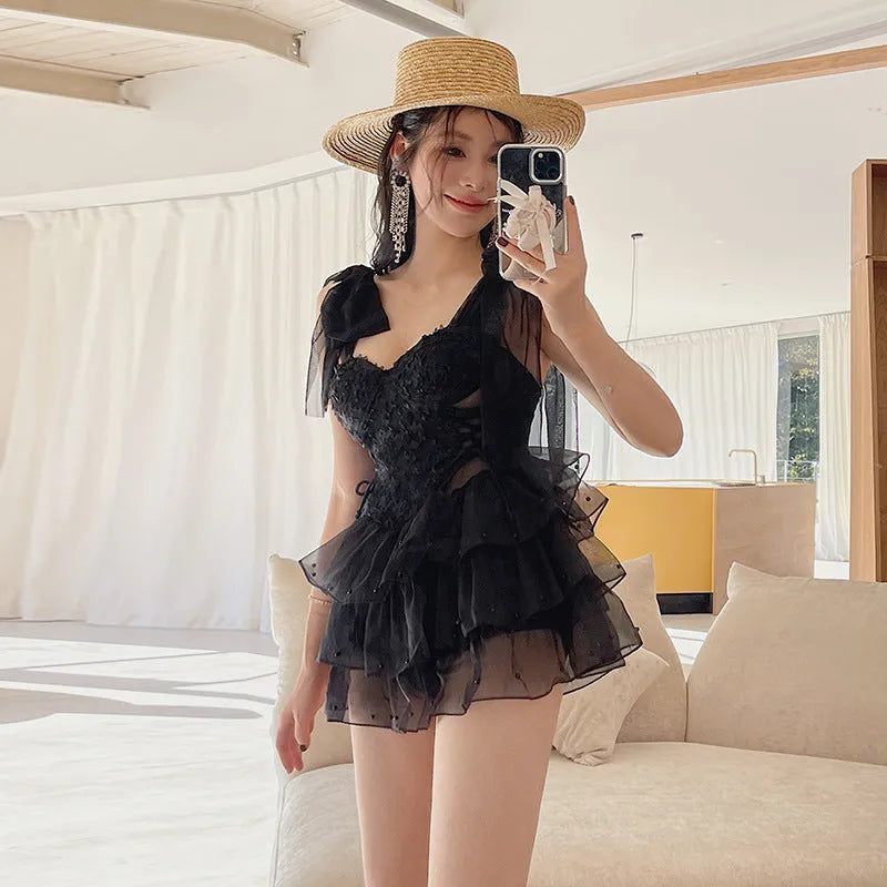 Black conservative one-piece swimsuit with chest gathered design and sleeveless nylon construction