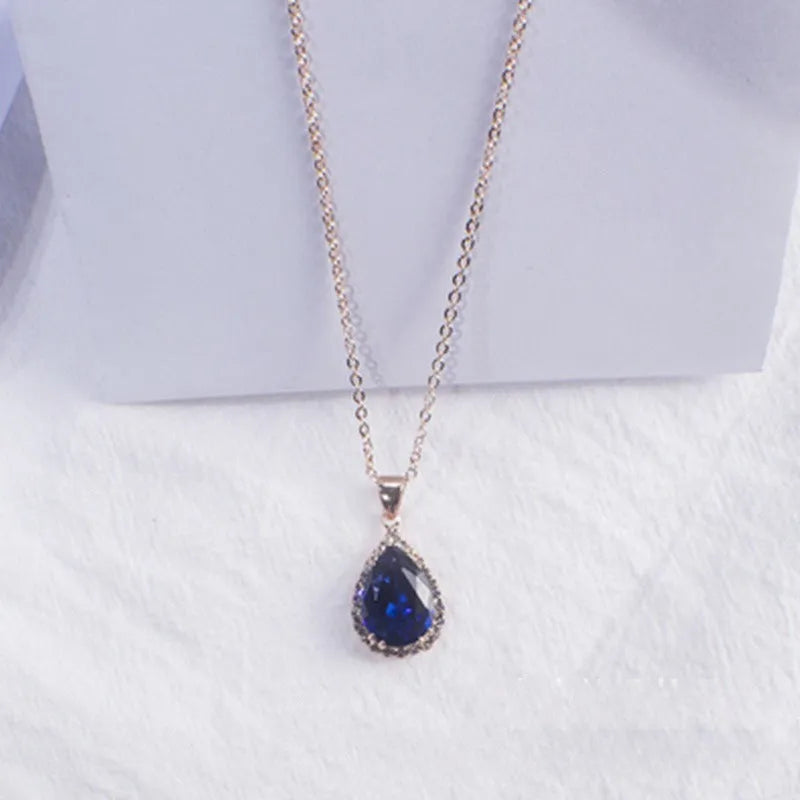 Rose gold water drop shape necklace with rhinestone geometric detailing in pink colour