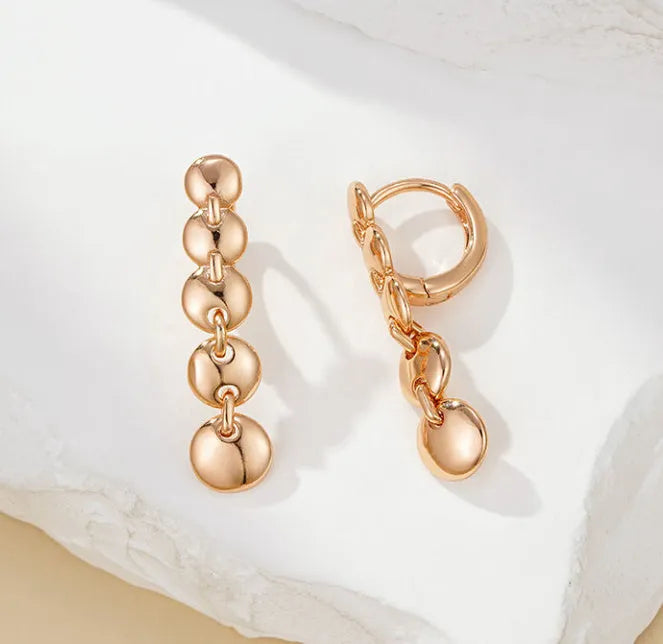 Gold coloured woven copper circle drop earrings with retro design