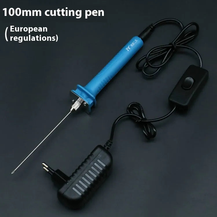 Blue plastic-handled electric foam cutter pen with adapter on a work surface.