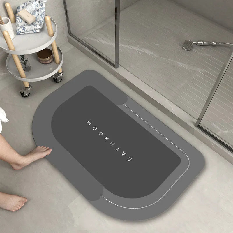 Blended fabric bathroom floor mat in oval and rectangular shapes on a tiled floor.