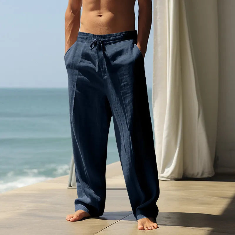 Man wearing loose fit solid colour cotton casual trousers in a leisure setting.
