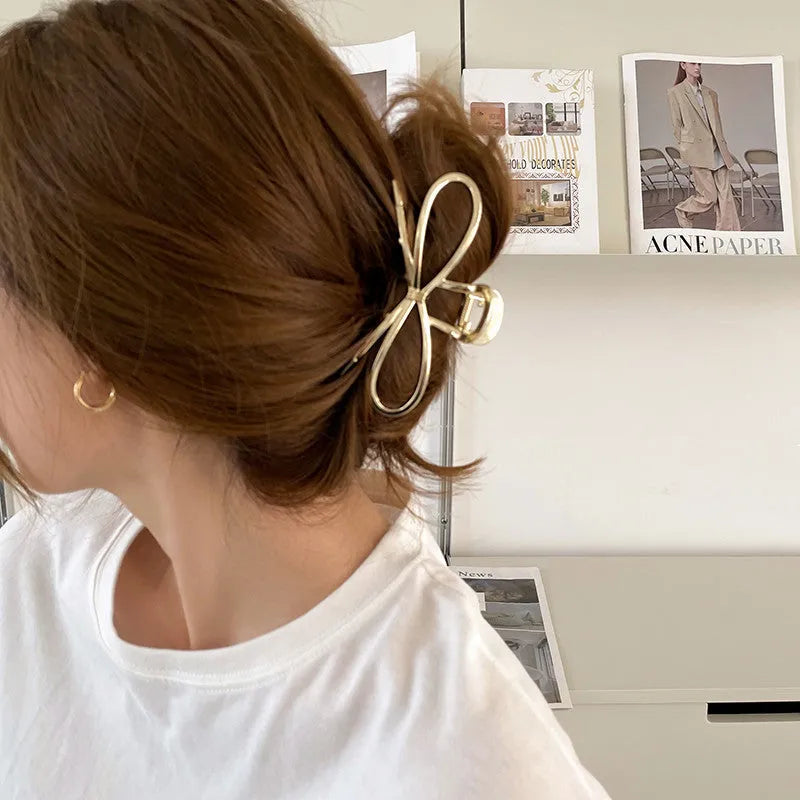 A silver women's hair barrette with a decorative Korean-style bow and an alloy clip.