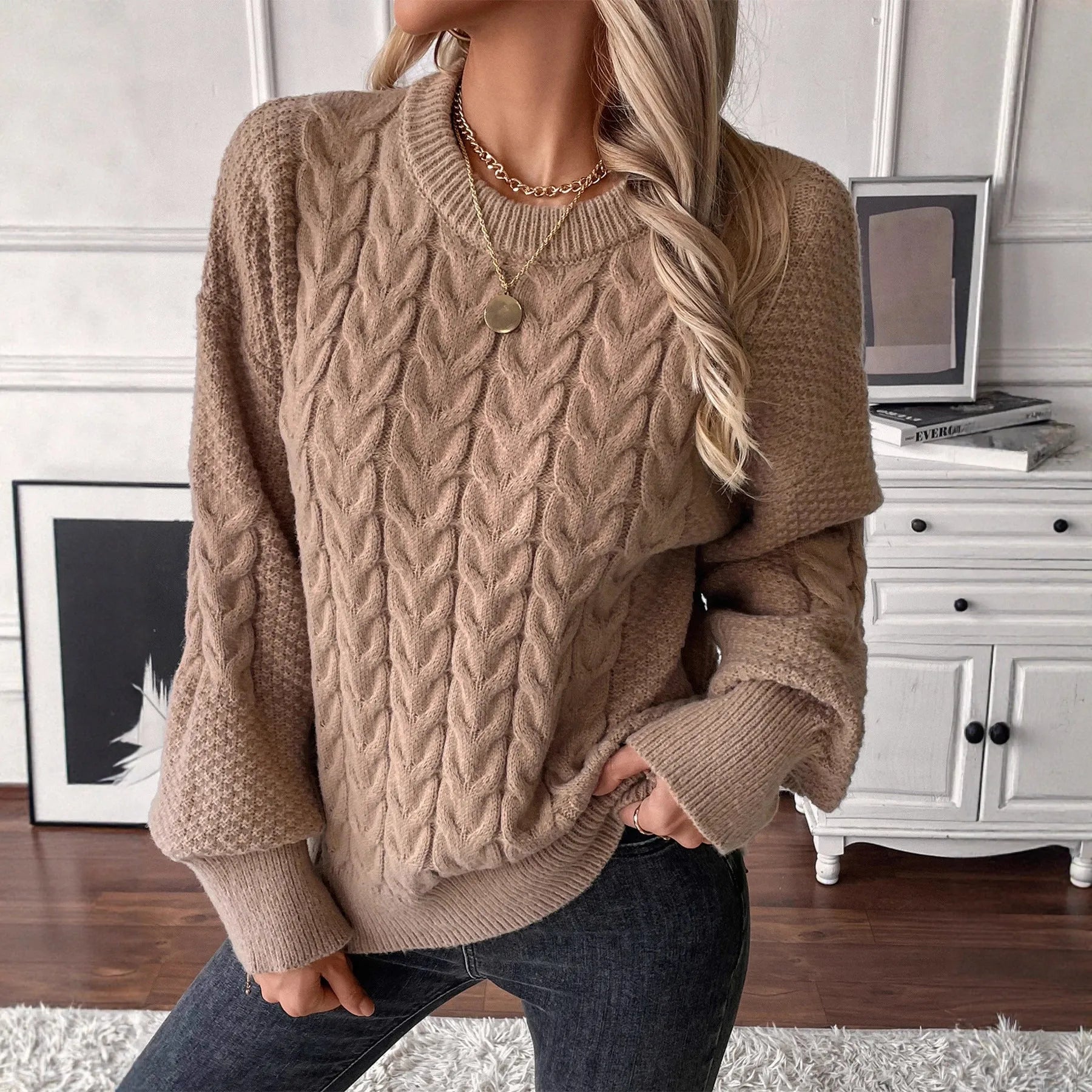 Women's beige loose-fit round neck casual pullover sweater on a hanger.