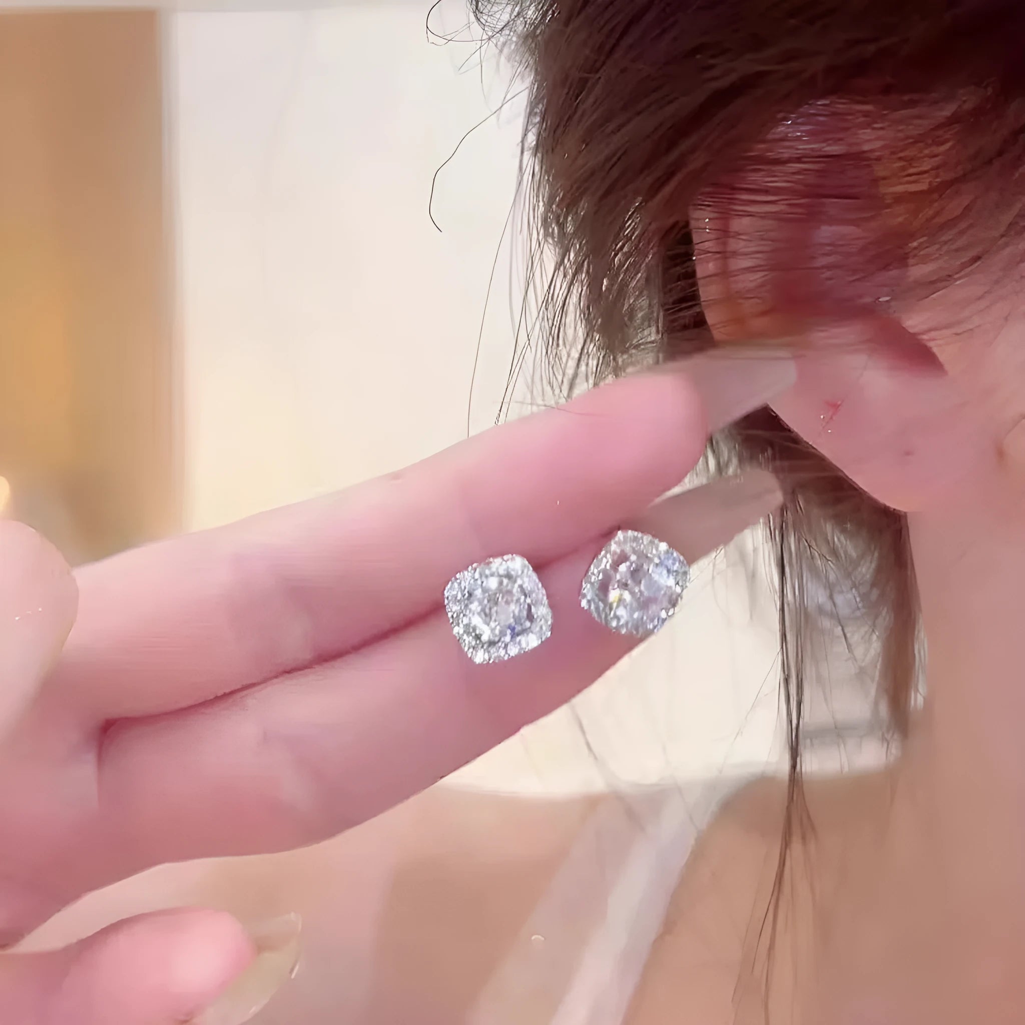 A pair of square-shaped diamond-treated alloy earrings on a white background, showing silver and gold colour options.