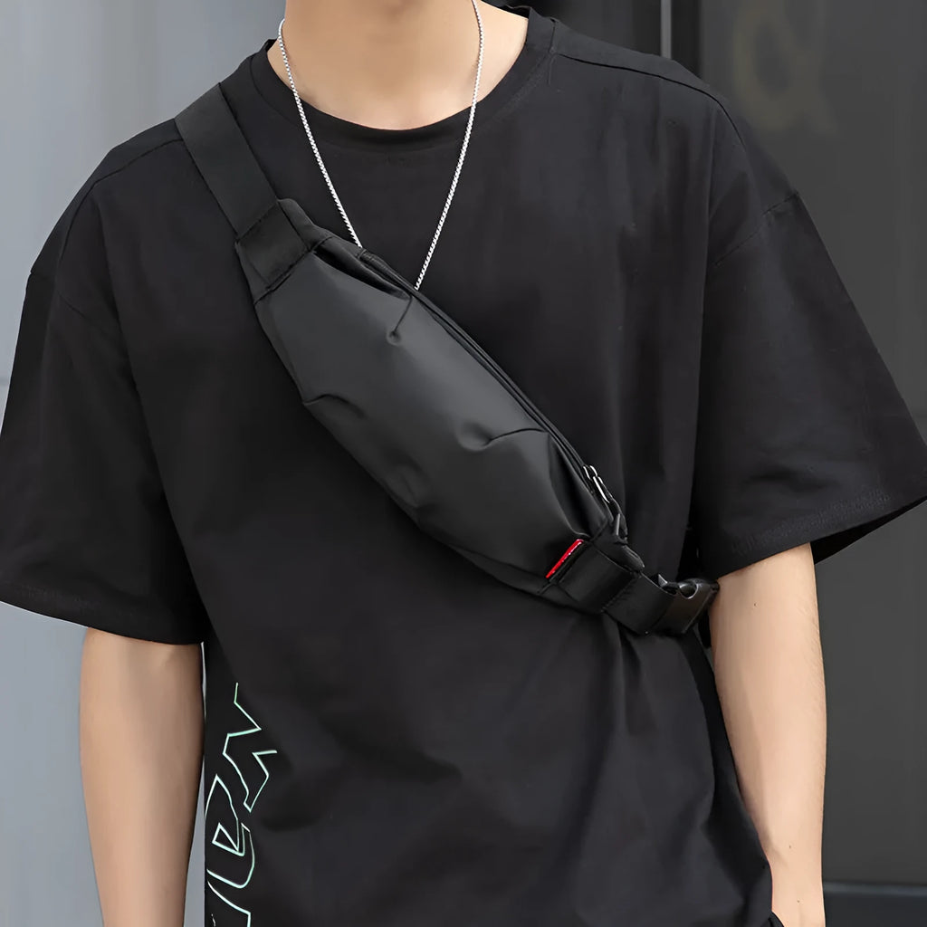 Black Oxford cloth waist pack with crossbody strap showing zipper closure