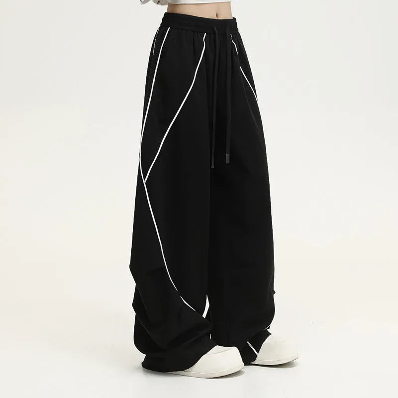 Black and white striped pleated wide-leg hip hop pants on a neutral background