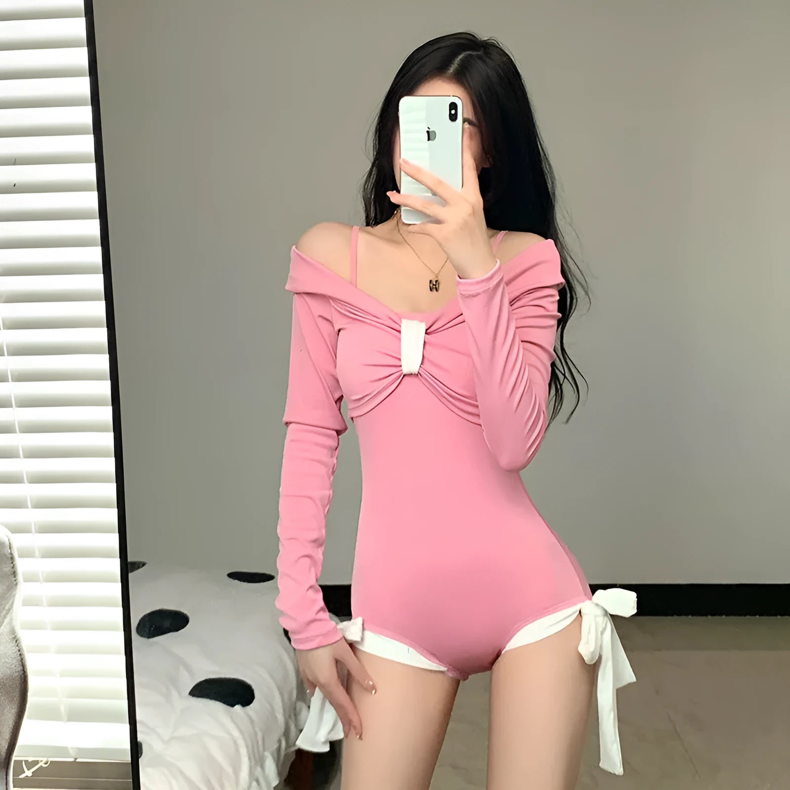 Women's long sleeve one-piece swimsuit in polyester fabric, available in pink or black colour with figure-flattering summer design