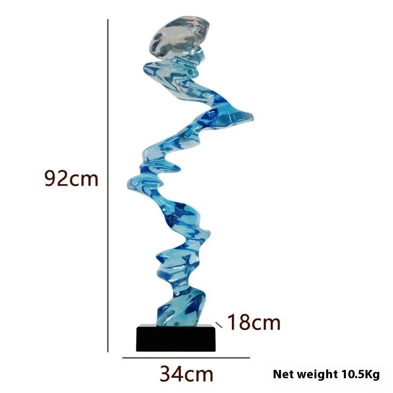 Modern abstract decorative ornament made from natural resin in a choice of gold, silver, or blue.