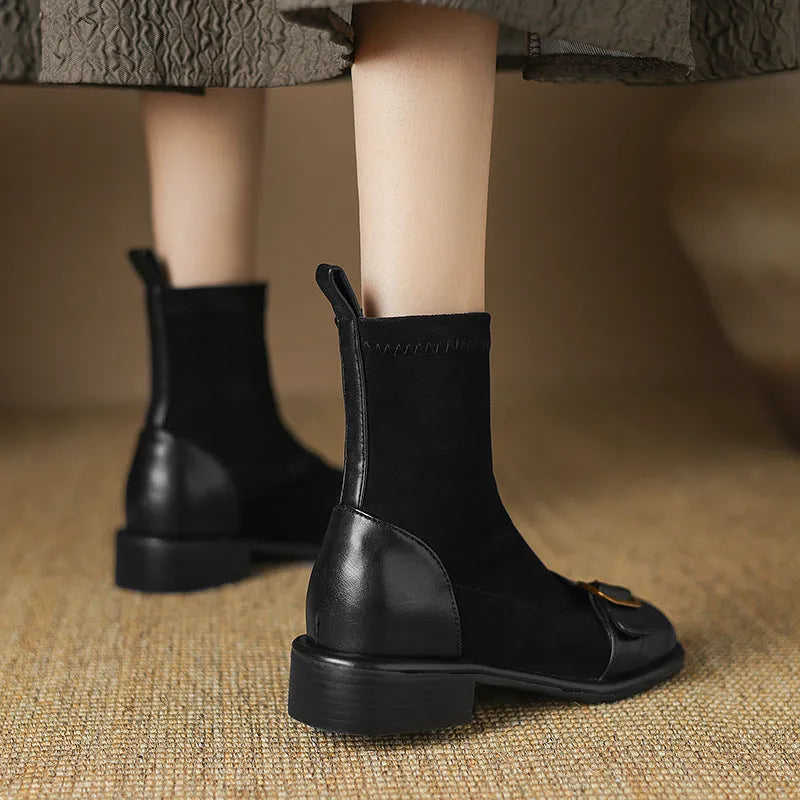 Women's black low heel Martin boots with belt buckle stitching and front lace-up closure on a round toe.