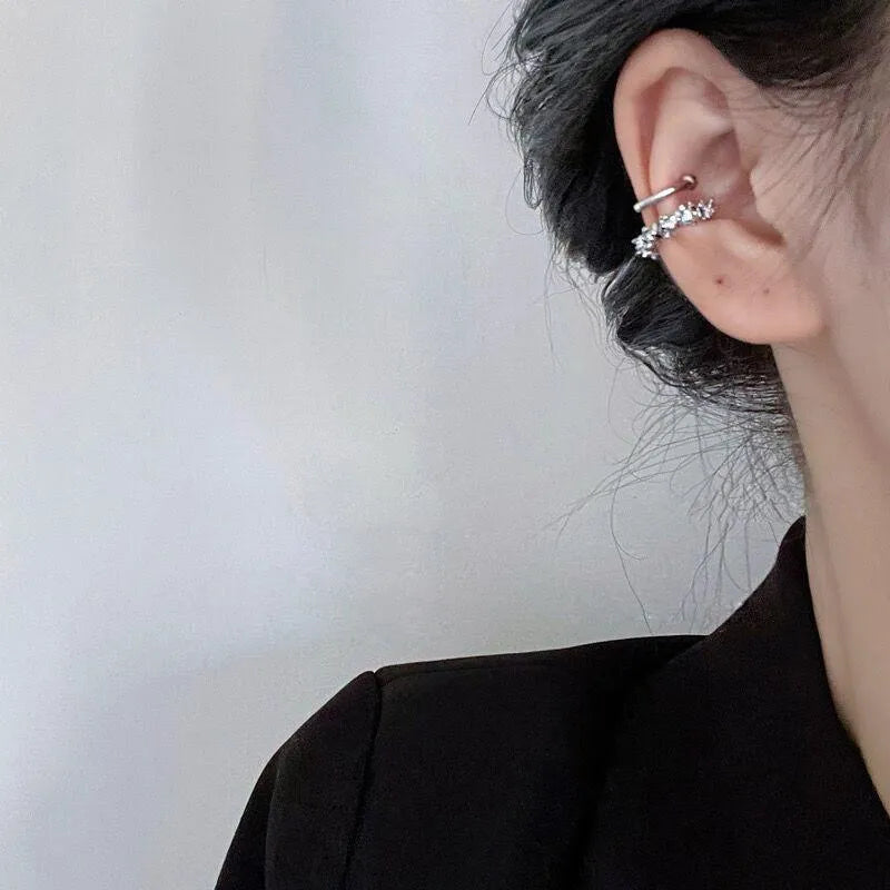 A pair of silver geometric irregular-shaped earrings with a frosted finish and clip-on fastenings.