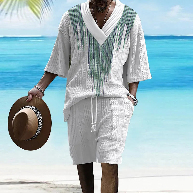 A man wearing a printed drop-shoulder knitted short-sleeved top with matching shorts in a casual setting.
