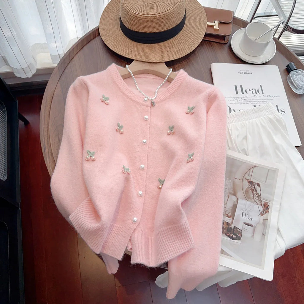 Pink cashmere cardigan coat with bead detailing, shown with a round neck and slim fit.