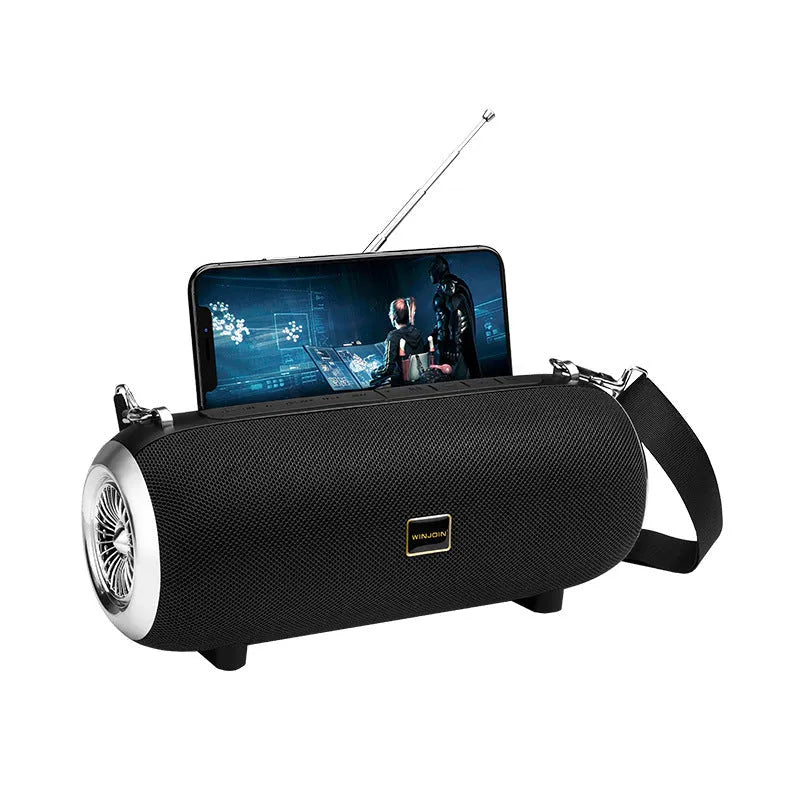 F666 fabric portable Bluetooth speaker with shoulder strap, retractable FM antenna, and mobile phone stand shown in black.