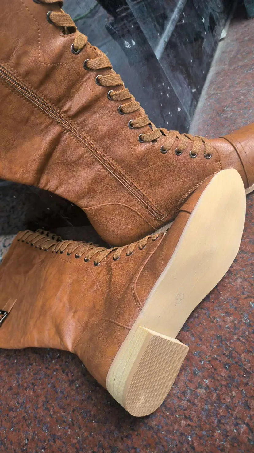 Women's black knight ankle boots with a cross-strap design across the front.