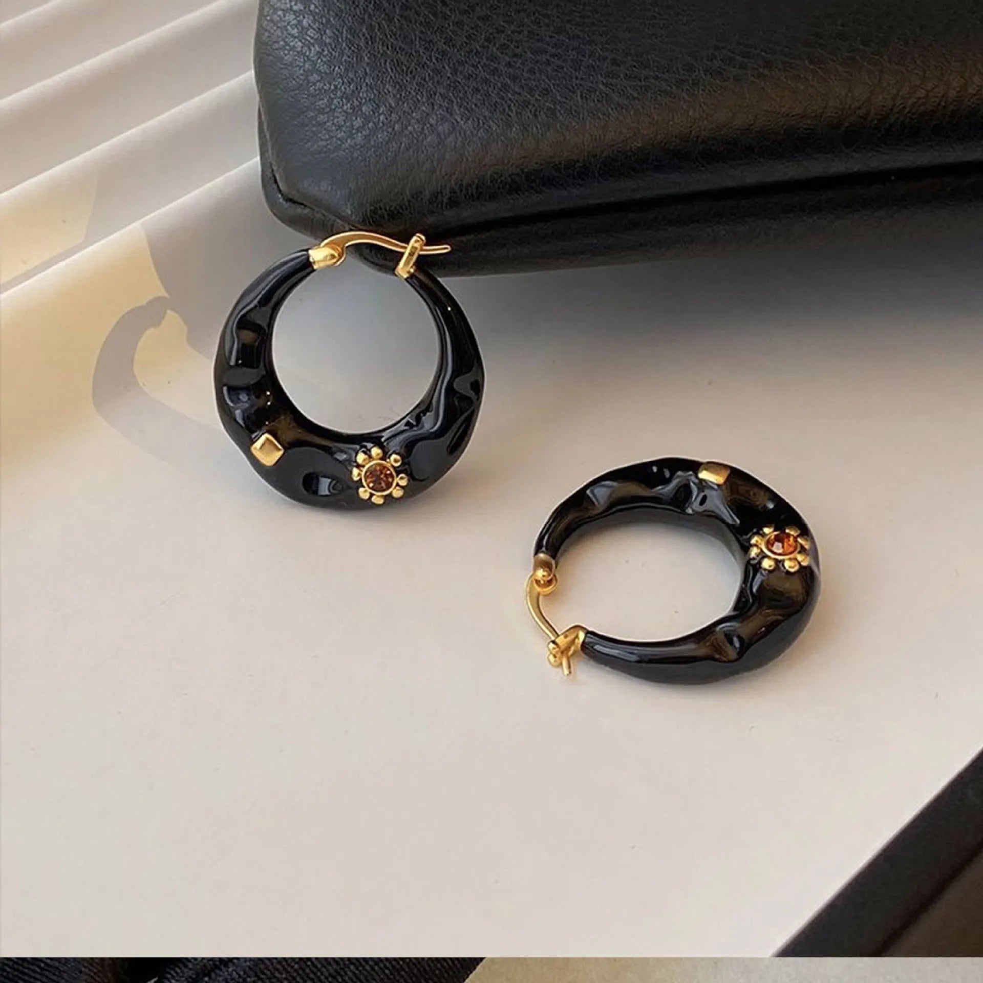 Hong Kong style retro ear studs with dripping oil finish and rhinestone detail in black and red colours