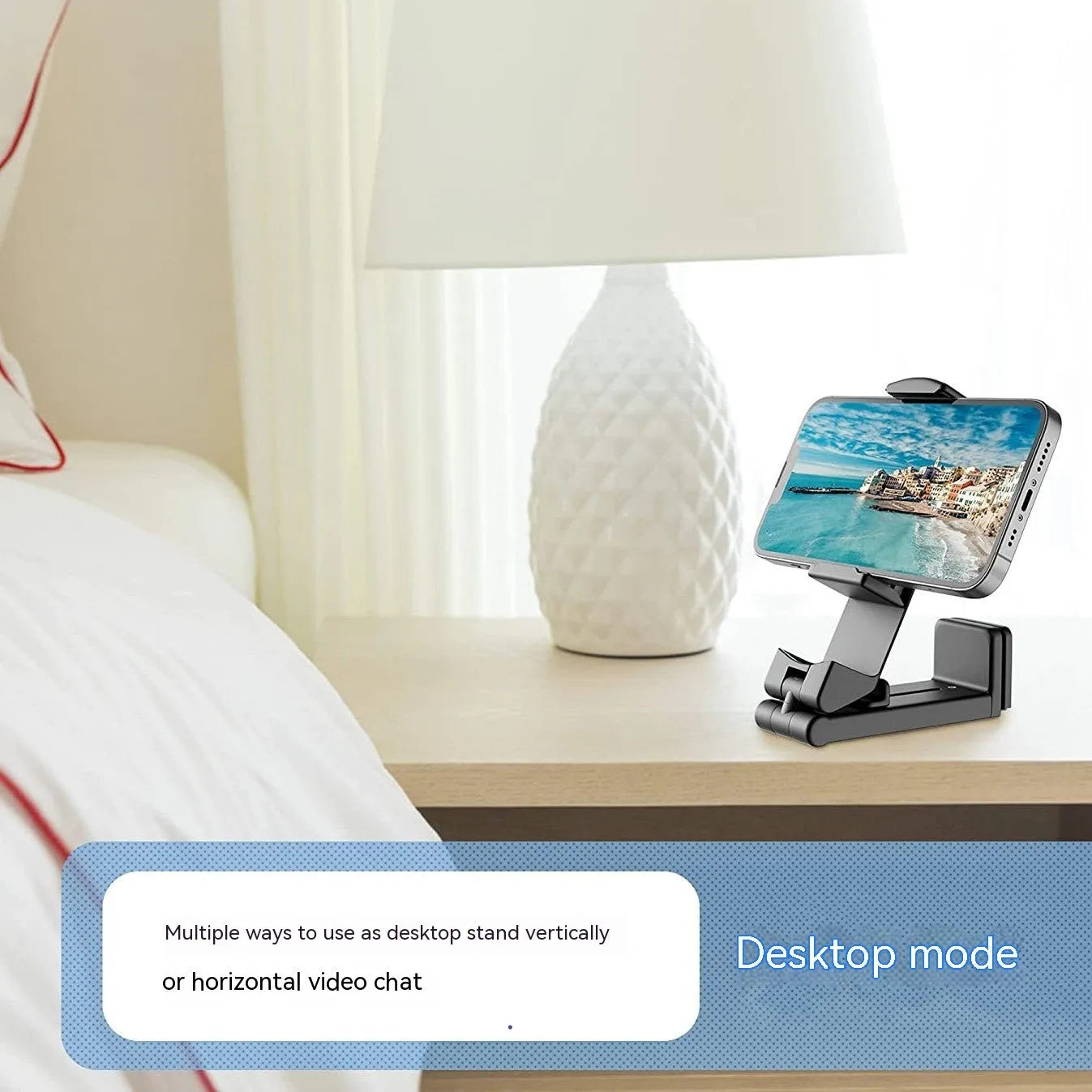 Foldable rotating universal phone holder in black, shown in an open position holding a mobile phone.