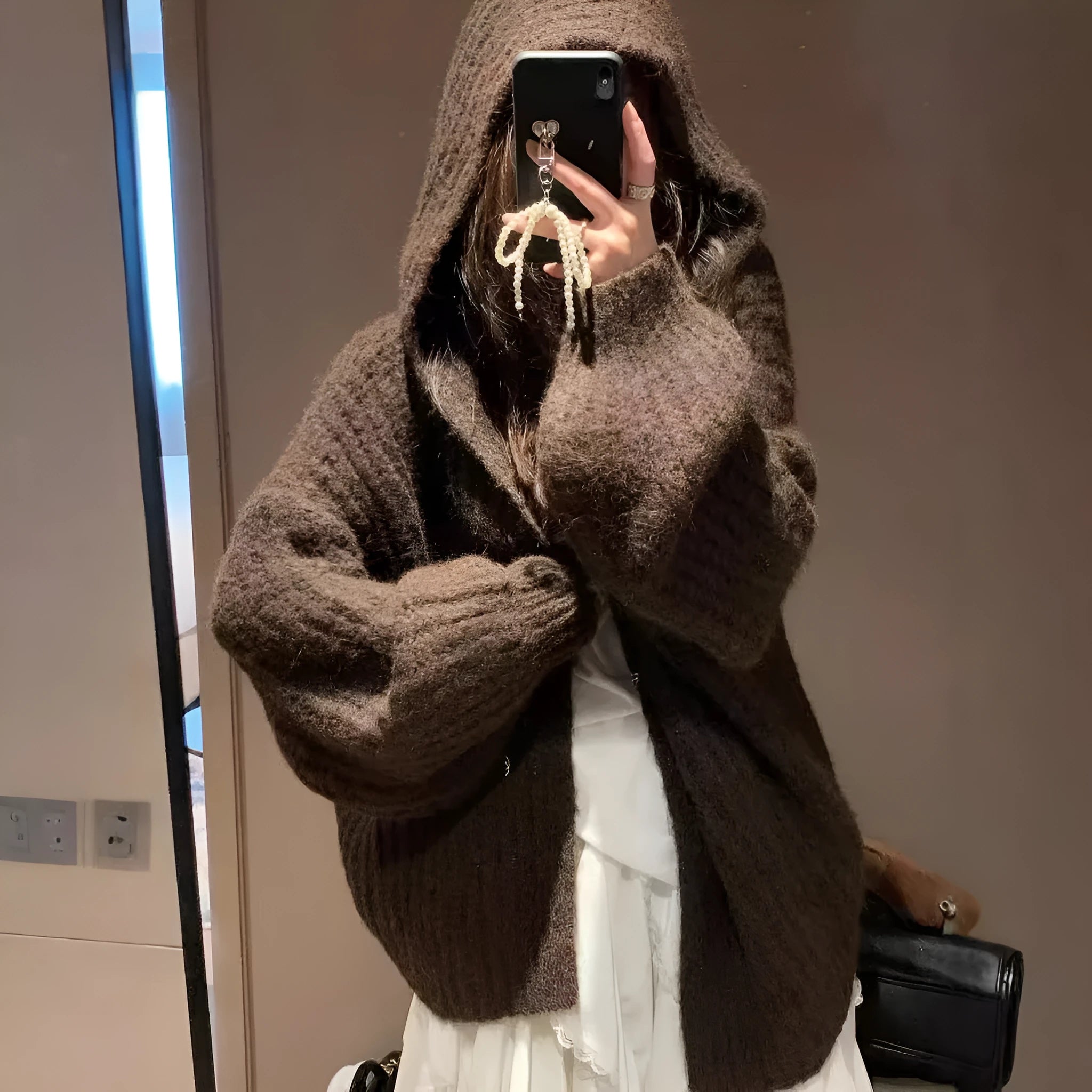 Women's dark grey retro Maillard knit hooded cardigan on a hanger, showing loose fit and regular sleeves.