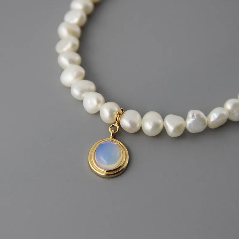 Round medal pearl necklace with geometric silver pendant and irregular freshwater pearls