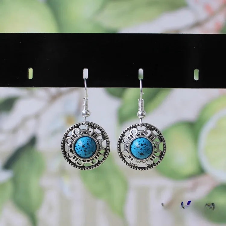 Miao silver earrings with turquoise geometric flower disk and totem patterns