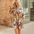 Orange floral print women's mini dress with lace-trimmed V-neck and long sleeves.