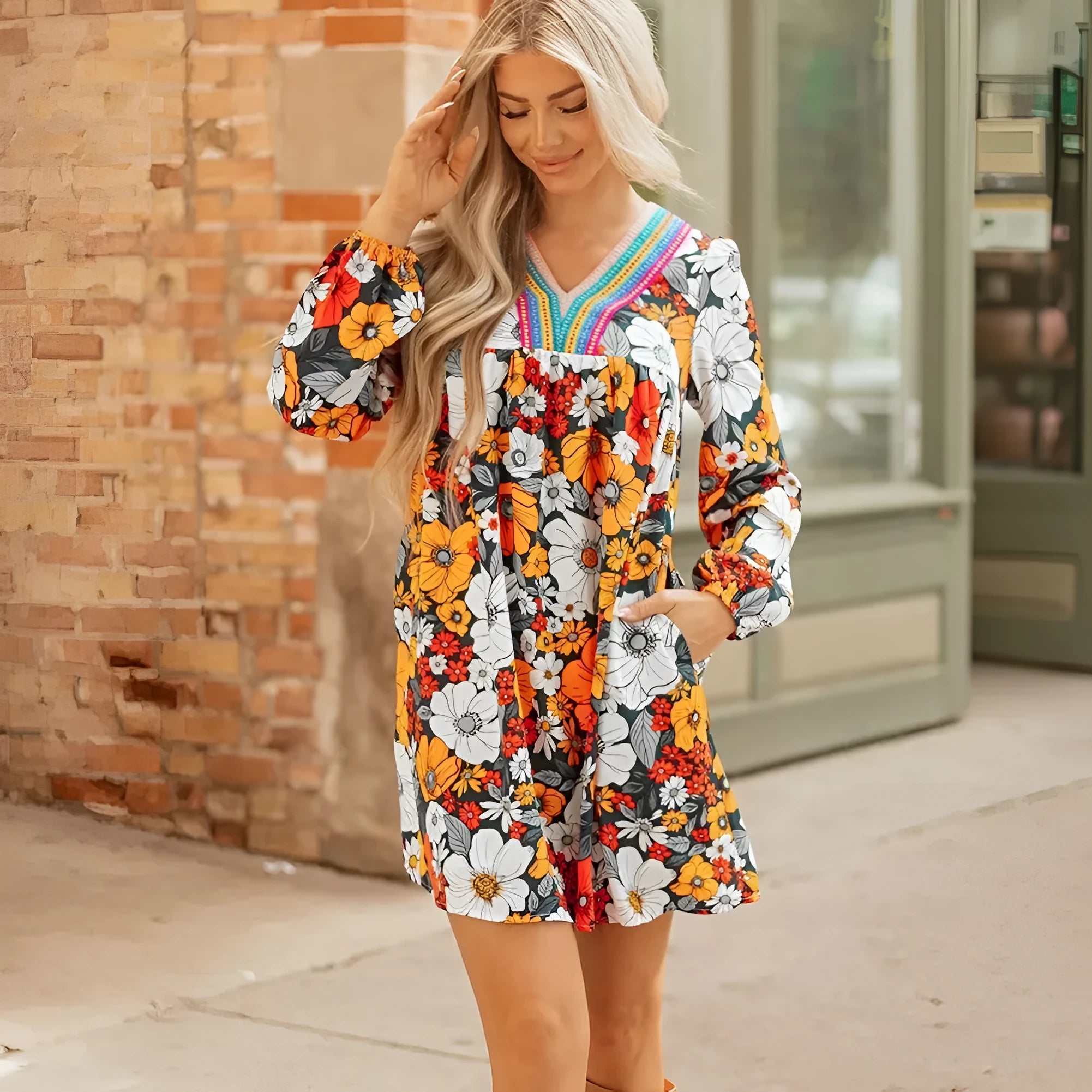 Orange floral print women's mini dress with lace-trimmed V-neck and long sleeves.