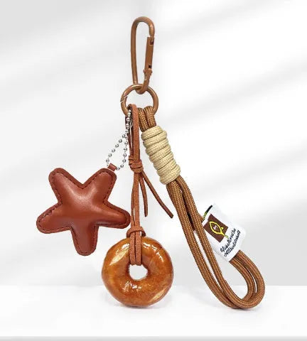 Handmade soda bread style handbag pendant charm with cartoon design and brown strap