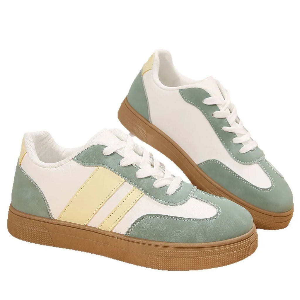 Women's retro sports shoes in white with green candy colour accents and cross-strap details on PU leather upper.