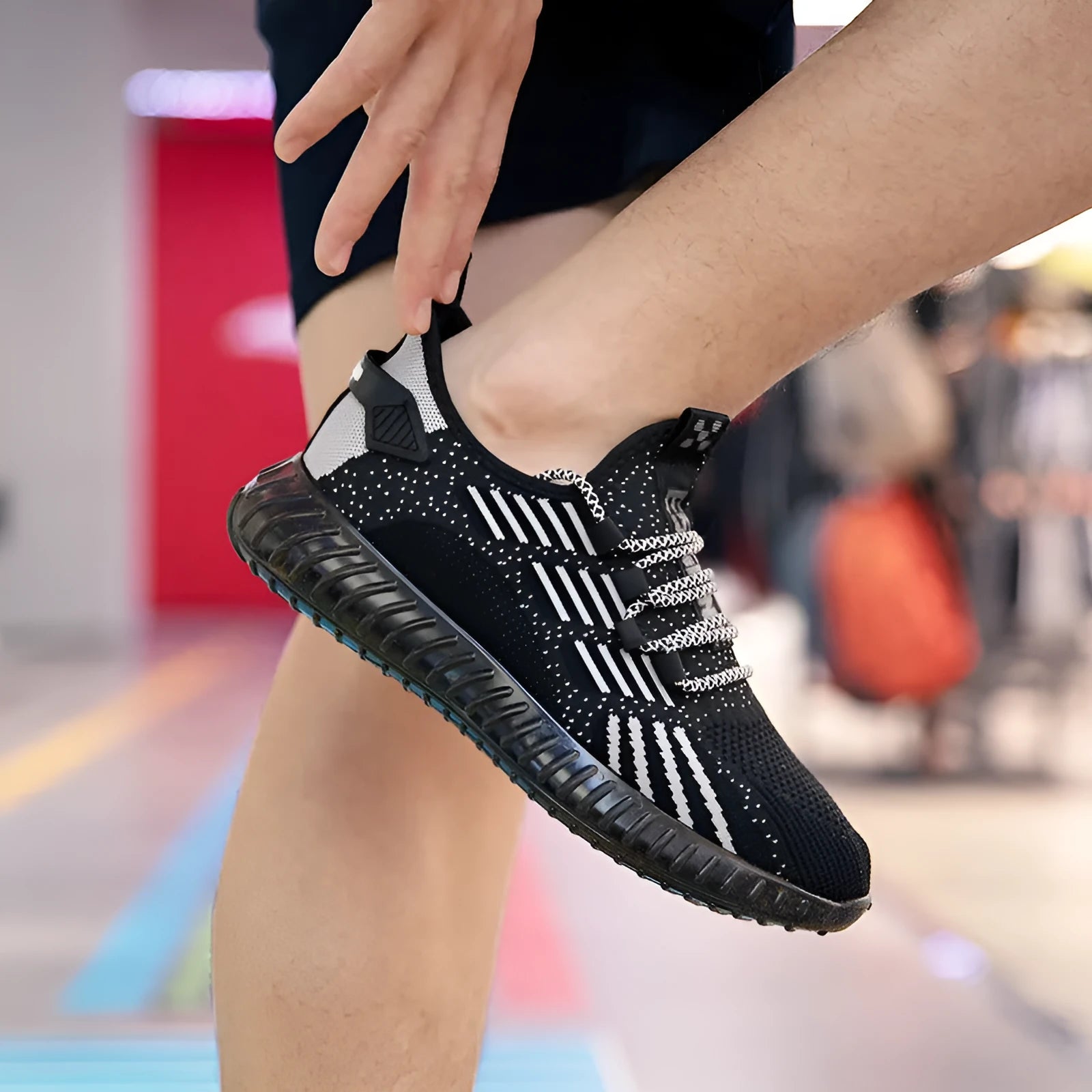 Men's breathable flying fabric sports shoes in black, showing round toe and flat platform heel.