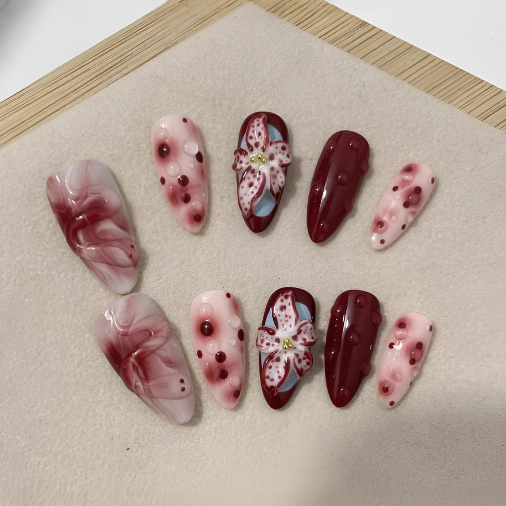 Almond-coloured false nails with hand-painted three-dimensional rose and tulip floral designs