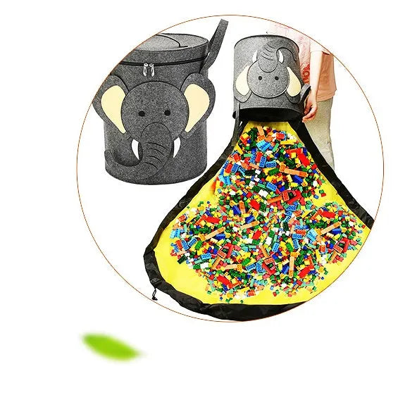 Green cube-shaped felt storage bag with pull rope lying flat as a play mat.